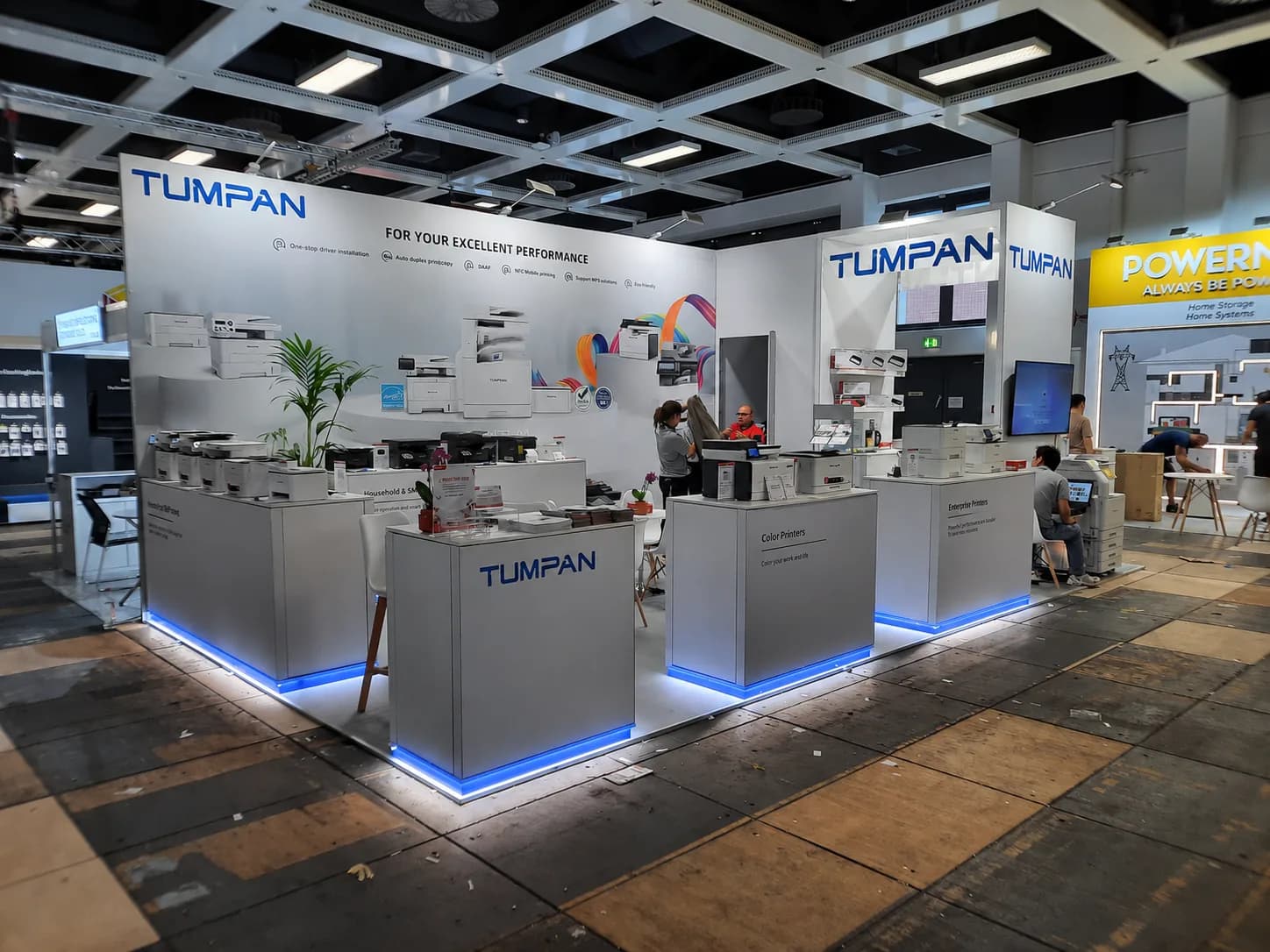Modular stand with a white graphics wall, product plinths and blue LED plinth lighting